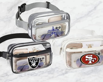 May include: Three clear plastic fanny packs with adjustable straps. The fanny packs have different team logos: Dallas Cowboys, Las Vegas Raiders, and San Francisco 49ers.