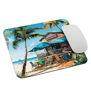 May include: A rectangular mousepad with a beach scene, a bar, palm trees, and the text "It's 5 o'clock somewhere." A white computer mouse is on the right. The bar is labelled "Bubba's Bar". The scene evokes a tropical holiday.