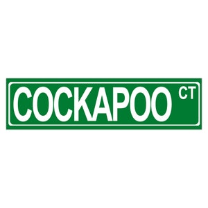 Pode incluir: Placa de rua verde com texto branco que diz "COCKAPOO CT".