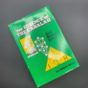 May include: A green book titled "The Essence of the Cabalah" with the text "Tarot Hebrew English." The cover features illustrations and the author's name, William Eisen.