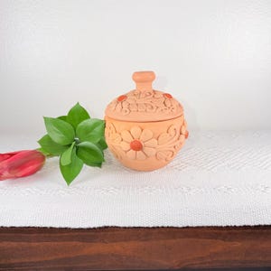 May include: A set of three ceramic mugs with a speckled, matte finish. The mugs are in shades of cream, light gray, and dark gray. Each mug has a simple, minimalist design and a rounded handle. Perfect for coffee or tea.