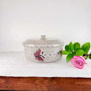 May include: A set of three ceramic mugs with a speckled, matte finish. The mugs are in shades of cream, light gray, and dark gray. Each mug has a simple, minimalist design, perfect for coffee or tea.