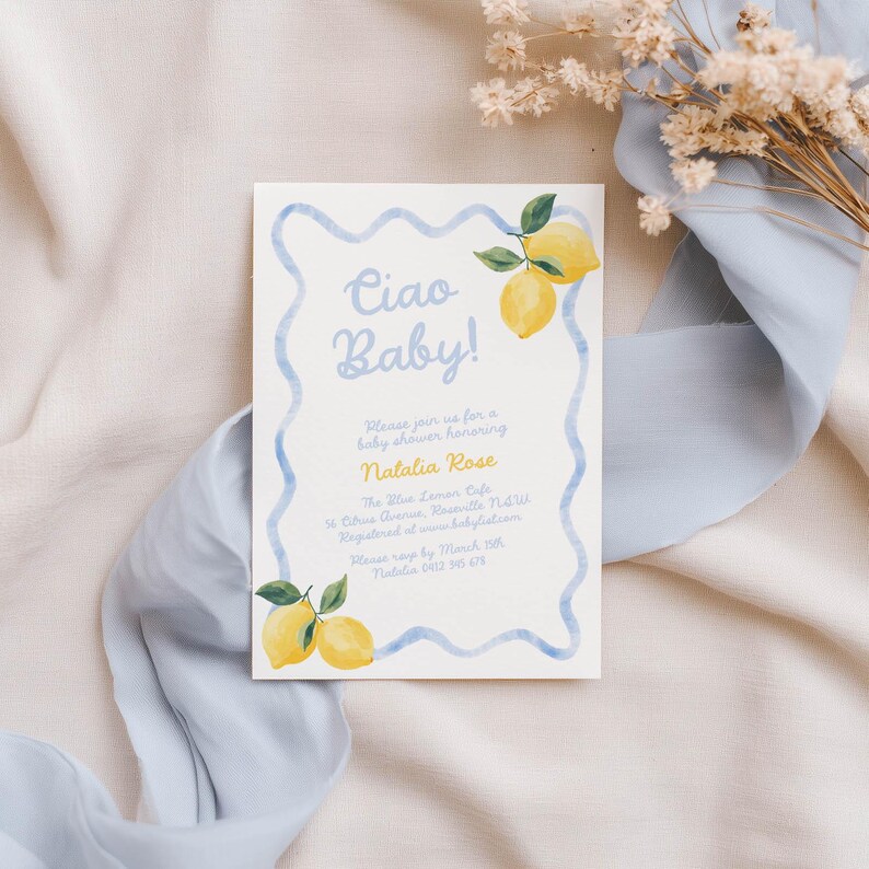 May include: A baby shower invitation with a watercolor design. The invitation features the text "Ciao Baby!" in light blue, along with details about the event, including the name "Natalia Rose". Lemon illustrations and a blue wavy border complete the design.
