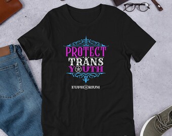 May include: Black t-shirt with a pink and blue design that says "Protect Trans Youth" with a star and the word "Euphorium" underneath.