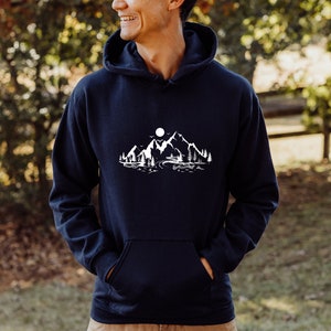 K&ouml;nnte beinhalten: Ein marineblauer Kapuzenpullover mit einem wei&szlig;en Motiv von Bergen, einem See und einem Vollmond.