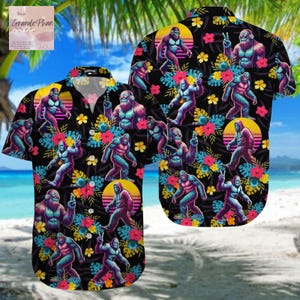 May include: A black button-up shirt with a tropical print featuring a repeating pattern of blue and purple Bigfoot figures, flowers, and palm leaves. The shirt has a retro 80s vibe.
