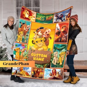 May include: A yellow and orange fleece blanket with a collage of cartoon lion characters from the movie The Lion King. The blanket features a variety of scenes from the movie, including Simba, Nala, Pumbaa, and Timon. The blanket also has the text "CUSTOM NAME" in a brown banner.