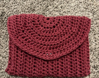 Hand made crochet maroon clutch wallet! Black spiral design fabric lining and a magnetic snap button to close.