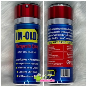 May include: A blue and red can with the text "IM-OLD Therapeutic Spray" and "NET WT 20 OZ 566g (591ml)". The can lists the product's benefits, including "Lubricates", "Penetrates", "Stops Knee Squeaks", "Silences Bone Cracks", "Loosens Stiff Parts", and "Stiffens Loose".