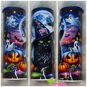 May include: A Halloween-themed tumbler featuring a black cat wearing a witch hat with a purple star. The design includes a full moon, ghosts, bats, jack-o'-lanterns, and a haunted house against a night sky. The tumbler has a blue rim and the text "AZ Cactus Creations".
