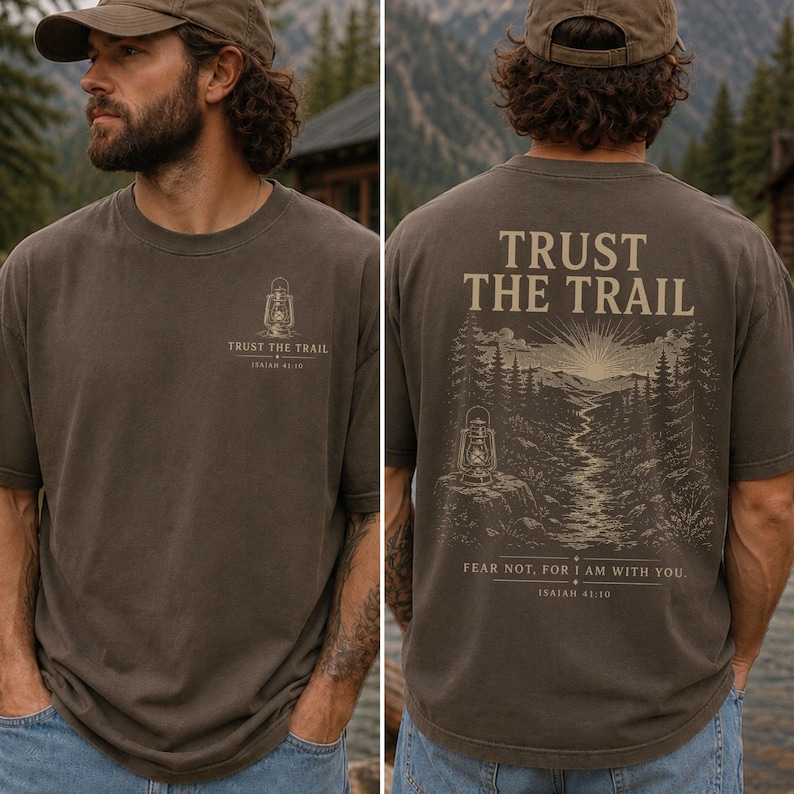 Comfort Colors men's Christian shirt featuring a small lantern chest graphic with Trust the Trail and Isaiah 41:10, plus a large back design with a mountain trail, sunrise, forest, and the scripture "Fear not, for I am with you." Men's Christian shirt, Isaiah 41:10 shirt, Bible verse shirt, Christian outdoors shirt, Christian nature tee, hiking shirt, Christian dad gift, faith-based apparel, Jesus shirt, Christian men's clothing.