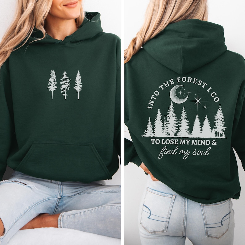 May include: A dark green hooded sweatshirt with a white graphic print of trees and the text "Into the forest I go to lose my mind & find my soul".