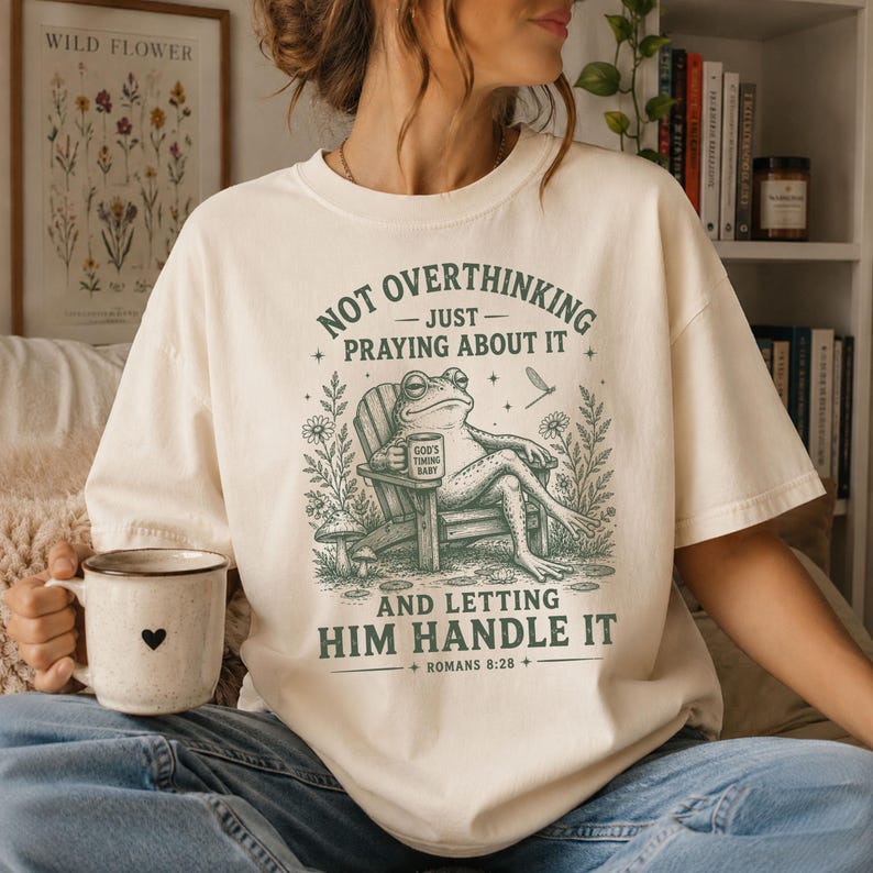 Not Overthinking Just Praying About It And Letting Him Handle It Comfort Colors Funny Christian Shirt Featuring Relaxed Frog In Adirondack Chair Holding Gods Timing Baby Mug With Romans Eight Twenty Eight Scripture Christian Humor Shirt Christian Frog Shirt Faith Based Shirt Womens Christian Shirt
