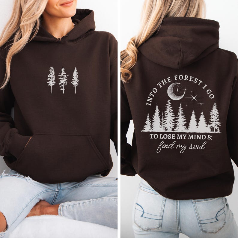 May include: Brown hooded sweatshirt with a white graphic of trees on the front and a white graphic of trees, a crescent moon, and stars with the text "Into the forest I go to lose my mind & find my soul" on the back.