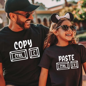 May include: A black t-shirt with the text "COPY" and a graphic of the computer keys "CTRL" and "C". A black t-shirt with the text "PASTE" and a graphic of the computer keys "CTRL" and "V".