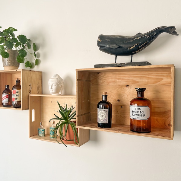 Wall shelf made of three different wine boxes and wooden boxes