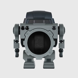 May include: A gray and black robot-shaped watch winder. The winder has a large circular opening in the center, with a dark interior. It features articulated arms and legs, and a dark gray top section with a window-like design.