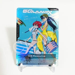 May include: A rectangular trading card featuring an anime-style illustration of two characters at the beach. The card displays the text EX Resource, EXR-001, and Japanese characters. The artwork shows a red-haired character and a dark-haired character.