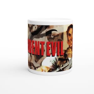 May include: White ceramic mug featuring a Resident Evil design. The mug has a wraparound graphic with the words "RESIDENT EVIL" in red block letters. The design includes images of characters from the video game.