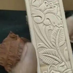Scroll border embossing tool for straps and belts