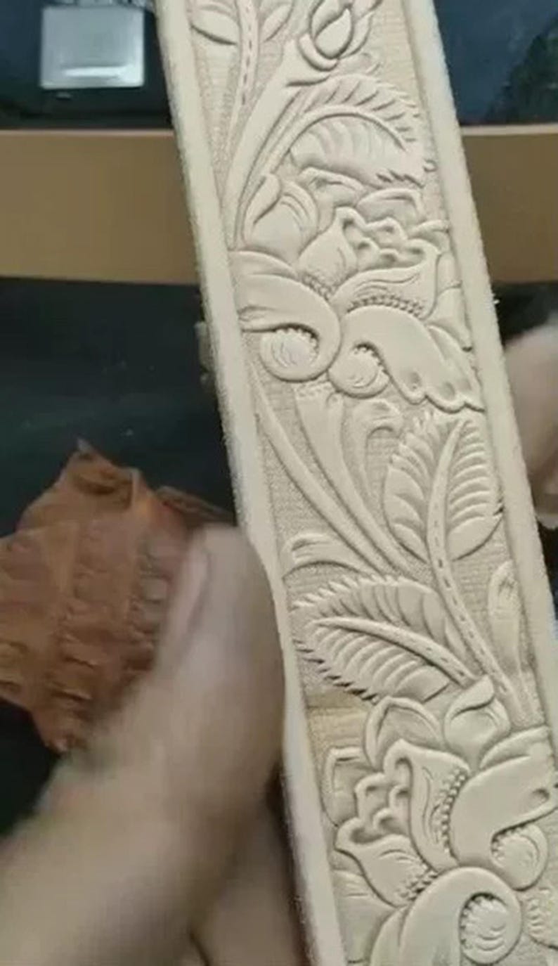 Scroll border embossing tool for straps and belts