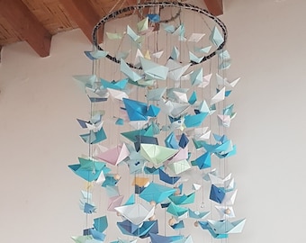 Hanging sculpture with origami boats. Wedding decoration, christening decor