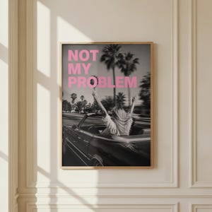 Not my problem poster with pink typography and retro aesthetic
Sassy quote wall art with bold pink text and vintage photo
Trendy typography print for modern room decor
Motivational attitude poster for girl room or bedroom
Aesthetic quote wall art with black and white background
Stylish statement poster for modern home decor