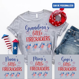 May include: A gray t-shirt with the text "Grandma's little FIRECRACKERS" and four red, white, and blue fireworks with names written on them. The names are Christ, Edison, Anderson, and Leon.  There are three other t-shirts with the same design but different text: "Nana's little FIRECRACKERS", "Mimi's little FIRECRACKERS", and "Gigi's little FIRECRACKERS".