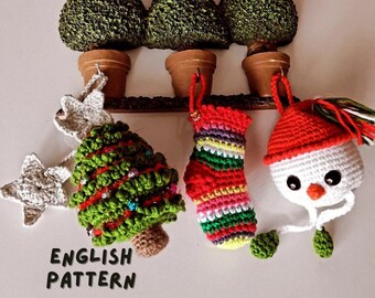 May include: A collection of handmade Christmas ornaments, including a crocheted Christmas tree, stocking, and snowman. The ornaments are in various colors, with red, green, and white being prominent. The text "ENGLISH PATTERN" is visible.