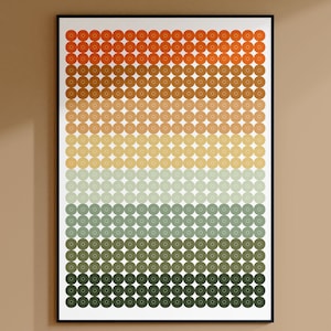 Op de afbeelding: Een ingelijst print met een geometrisch patroon van cirkels in tinten oranje, bruin, geel, groen en grijs. De cirkels zijn gerangschikt in rijen en kolommen, waardoor een verloop-effect ontstaat.