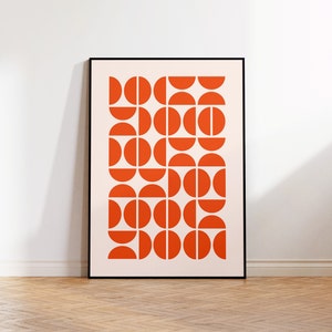 May include: A framed print with a geometric pattern of orange semi-circles on a white background.