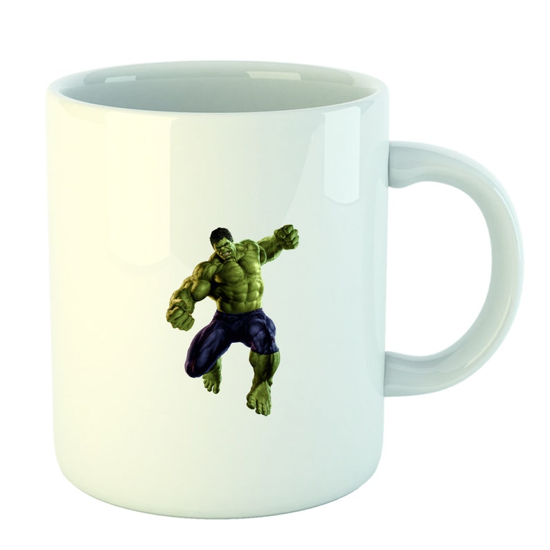 May include: White ceramic mug with a green and purple image of the Hulk, a fictional superhero, in a fighting pose.