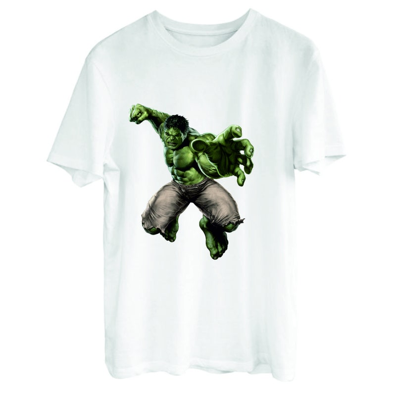 May include: White t-shirt with a green Hulk graphic. The Hulk is depicted in a dynamic pose, with his fist raised and his other hand outstretched.