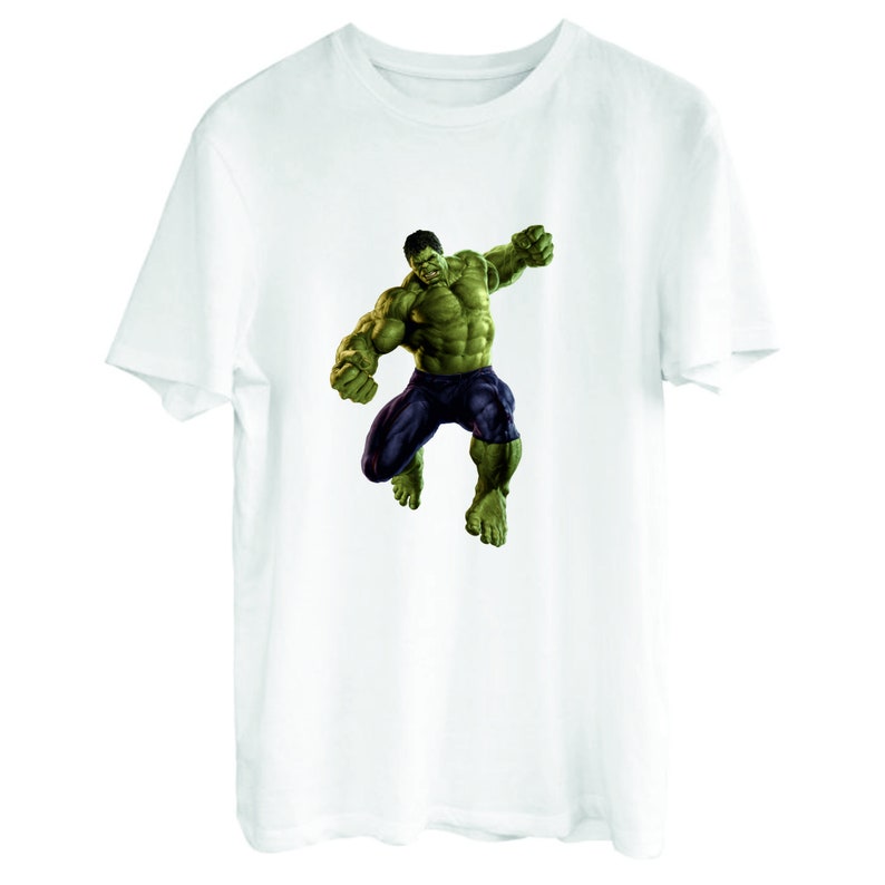 May include: White t-shirt with a green Hulk graphic. The Hulk is depicted in a dynamic pose, with his fists clenched and his face contorted in a fierce expression.