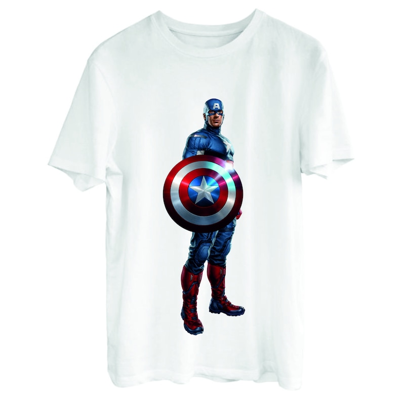 May include: White t-shirt with a printed image of Captain America standing with his shield in front of him. The shield is red, white, and blue with a star in the center.
