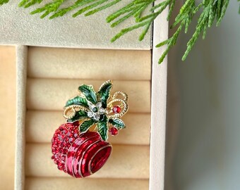 Broche de granada navideña: símbolo de abundancia. Accesorio festivo en verde y rojo.