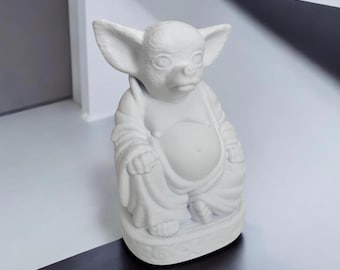 May include: White ceramic figurine of a seated dog with large ears, wearing a robe. The dog has a round belly and a serious expression.
