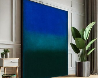 May include: Large abstract wall art with a gradient of blue and green hues. The artwork is framed in black and leans against a white wall. A potted plant with large green leaves sits nearby, adding a touch of nature to the room.