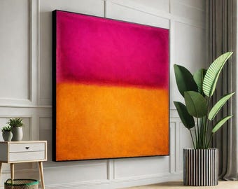 May include: Large abstract painting with a vibrant color block design. The top half is a bright pink, and the bottom half is a warm orange. The artwork is framed in a black border and hangs on a white wall.