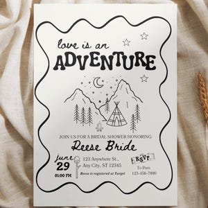 Puede incluir: Invitación en blanco y negro con el texto "love is an ADVENTURE" y una ilustración de montañas y un tipi. La invitación es para una despedida de soltera en honor a Reese Bride, el 29 de junio, 13:00.