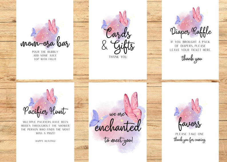May include: Set of six white signs with watercolor butterfly and star accents. Text includes "Mom-osa Bar", "Cards & Gifts", "Diaper Raffle", "Pacifier Hunt", "We are enchanted to meet you!", and "Favors".