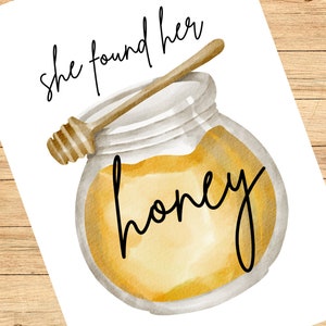 May include: A watercolour illustration of a glass jar filled with honey and a wooden honey dipper. The text "she found her honey" is written in black cursive above the jar.