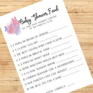 May include: A white Baby Shower Fend game sheet with fill-in-the-blank questions. The sheet features a watercolor design of pink and purple butterflies and text. Questions include a popular brand of diapers and a classic lullaby.