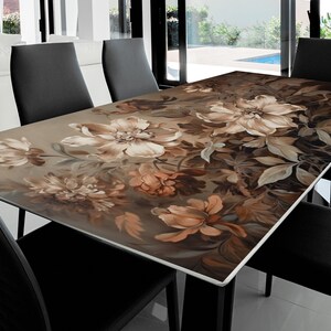 May include: A glass table top with a floral design featuring brown and white flowers and leaves. The table top is rectangular and has a glossy finish.