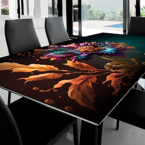 May include: A black glass table top with a colorful floral design. The design features a large flower with purple, blue, and orange petals, surrounded by gold leaves. The background is a dark teal color.
