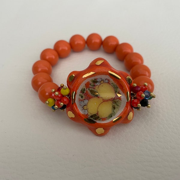 Sikelia bracelet, Sicilian bracelet, Caltagirone ceramic tambourine, elastic bracelet with salmon-colored coral paste pearls.