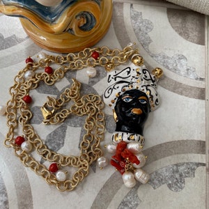 Necklace with long pendant in Caltagirone ceramic, Moor&#39;s head, hypoallergenic chain, coral and river pearls.