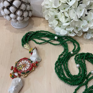 Long, multi-strand necklace with crystals, Caltagirone ceramic tambourine, scaramazze pearls and semiprecious stones.