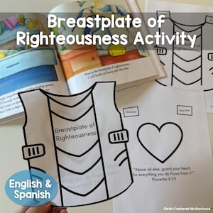 Puede incluir: Un recorte de papel blanco de una coraza con las palabras "Breastplate of Righteousness" impresas. La imagen también incluye una forma de corazón, un libro y el texto "English & Spanish".