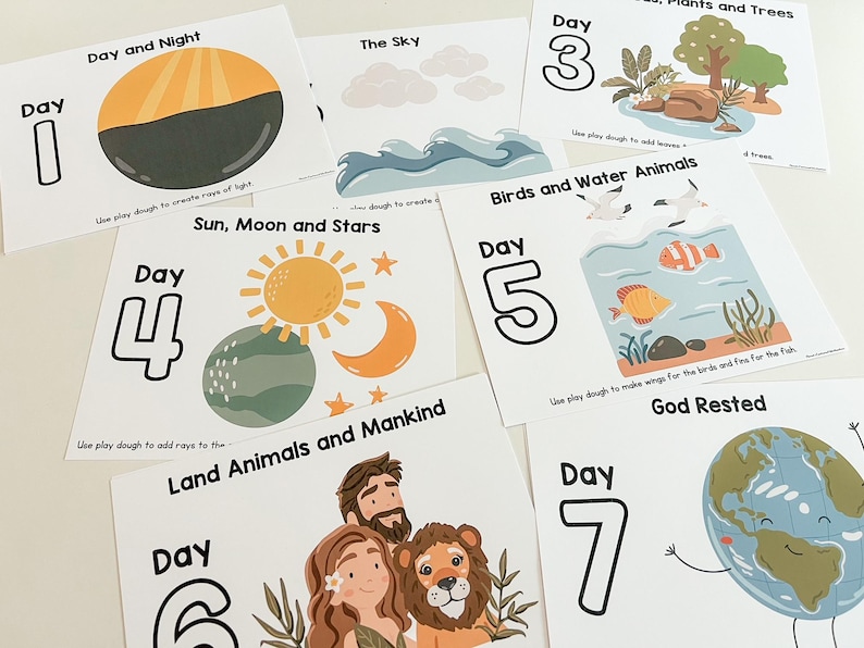May include: Seven colourful cards with illustrations and text about the days of creation. Each card features a day number, a title, and an image related to the day's creation event. The cards are designed for use with play dough.